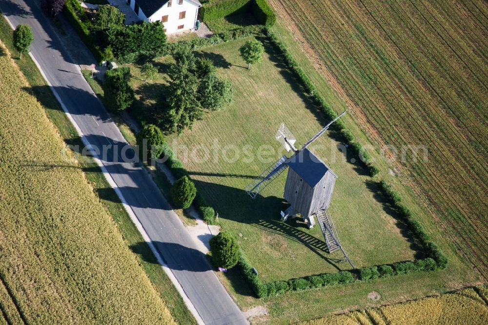 Talcy from above - Historic windmill on a farm homestead on the edge of cultivated fields in Talcy in Centre-Val de Loire, France