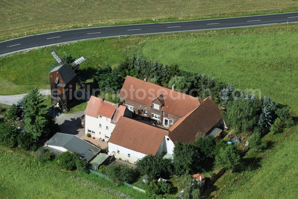 Aerial image Wellaune - Historic windmill on a farm homestead on the edge of cultivated fields in Wellaune in the state Saxony