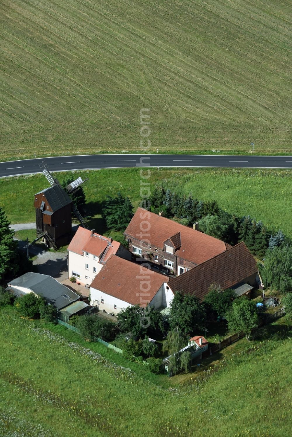 Aerial photograph Wellaune - Historic windmill on a farm homestead on the edge of cultivated fields in Wellaune in the state Saxony