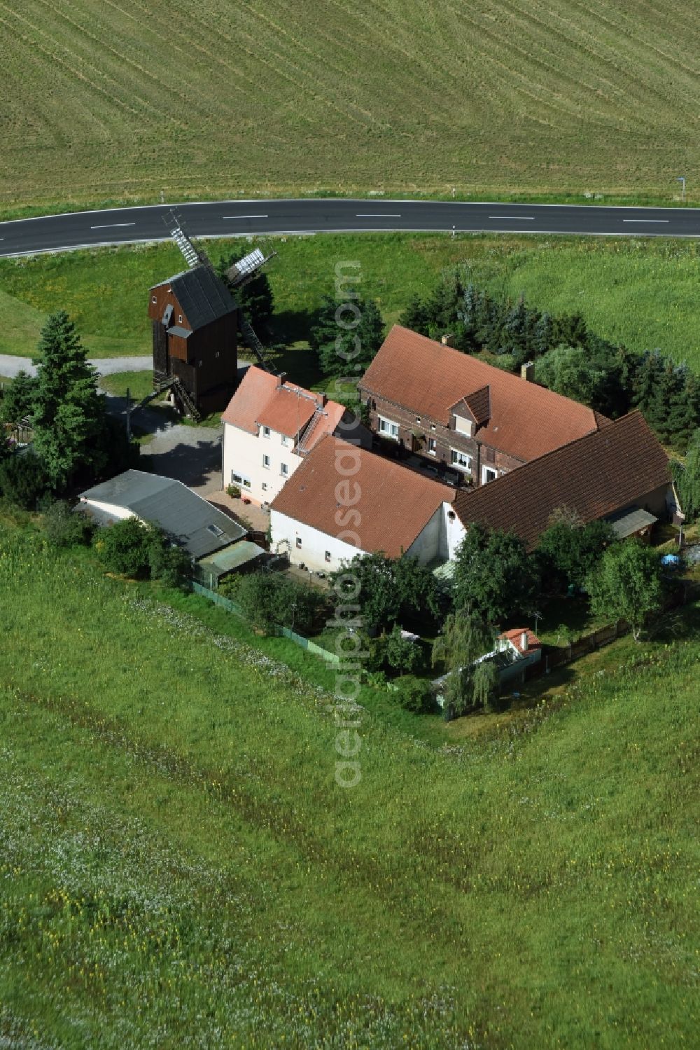 Wellaune from above - Historic windmill on a farm homestead on the edge of cultivated fields in Wellaune in the state Saxony