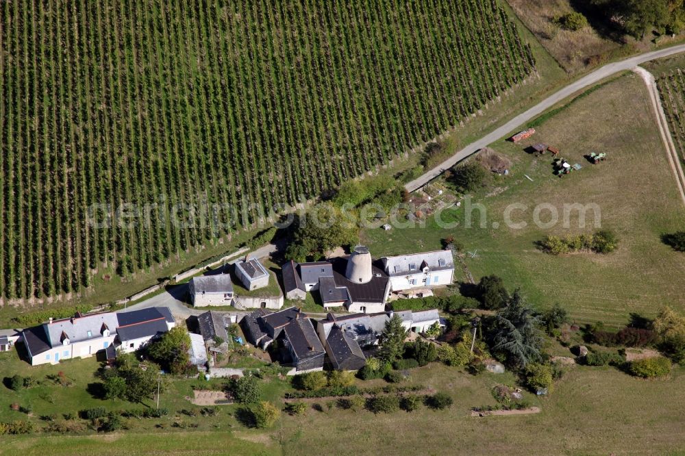 Savennieres from the bird's eye view: Historic windmill on a farm homestead on the edge of cultivated fields in Savennieres in Pays de la Loire, France