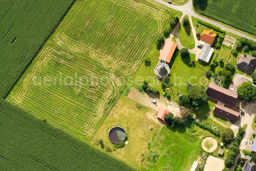 Aerial image Kutenholz - Historic windmill on a farm homestead on the edge of mown meadows in Kutenholz in the state Lower Saxony, Germany