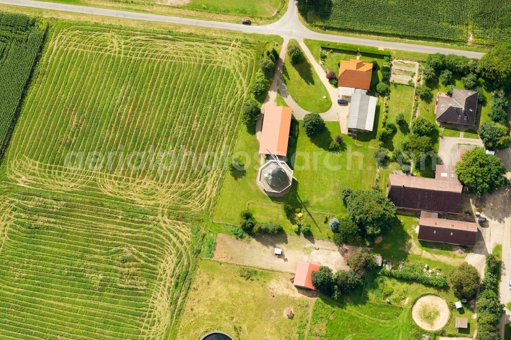 Aerial photograph Kutenholz - Historic windmill on a farm homestead on the edge of mown meadows in Kutenholz in the state Lower Saxony, Germany