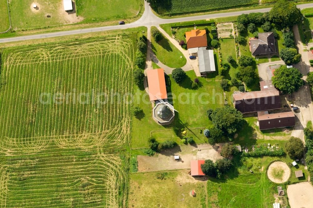 Kutenholz from above - Historic windmill on a farm homestead on the edge of mown meadows in Kutenholz in the state Lower Saxony, Germany