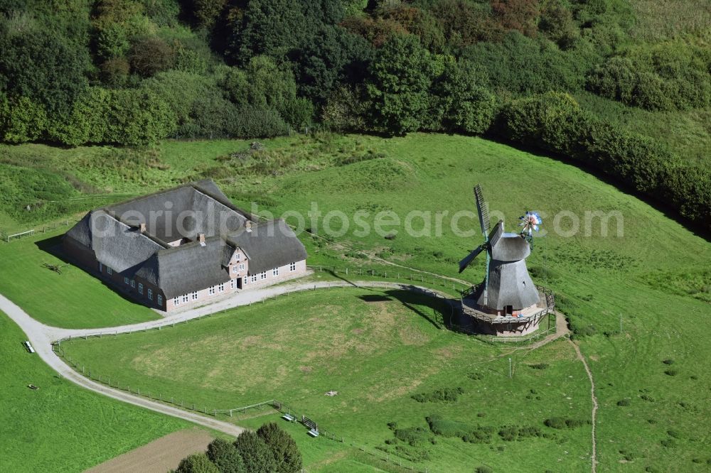 Rammsee from the bird's eye view: Historic windmill on a farm homestead on the edge of cultivated fields in Rammsee in the state Schleswig-Holstein