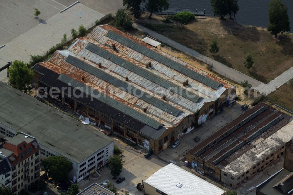 Berlin from the bird's eye view: Historic factory building at Platz am Kaisersteg on the riverbank of the Spree in the Oberschoeneweide part of Berlin in Germany. The building is located in the industrial area amidst factories and industrial sites on the riverbank