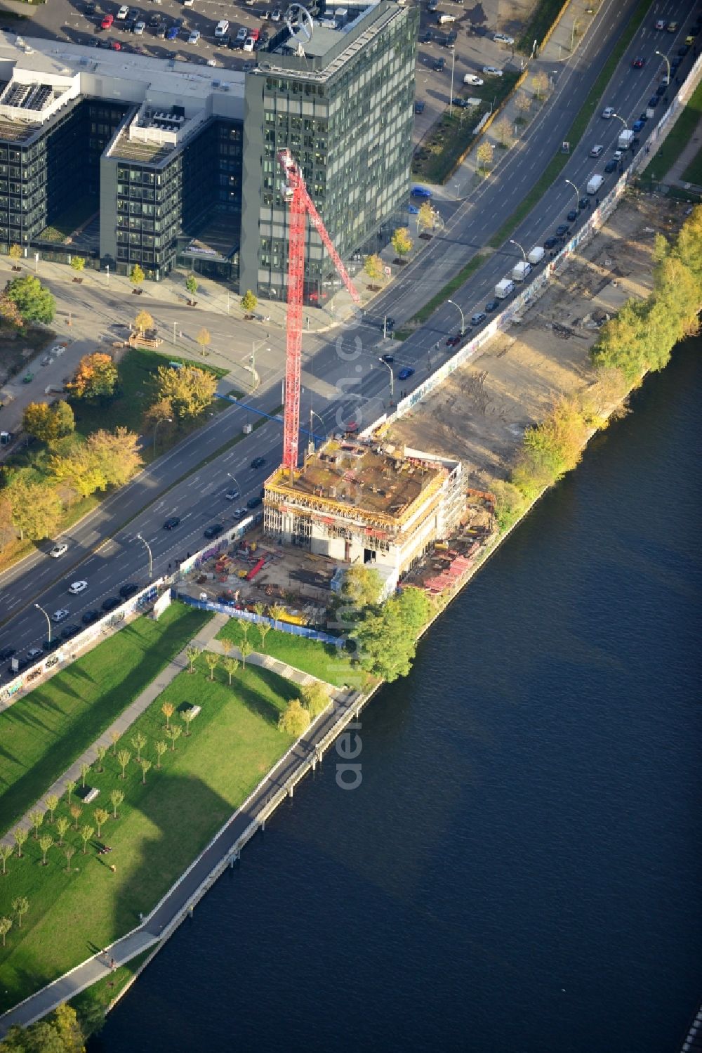 Berlin from above - Construction site of Project Living Levels at Muhlenstrasse on the banks of the River Spree in Berlin - Friedrichshain. On the grounds of the Berlin Wall border strip at the EastSideGallery, the company Living Bauhaus is building a futuristic high-rise residential. The real estate service company City & Home GmbH manages the available apartments