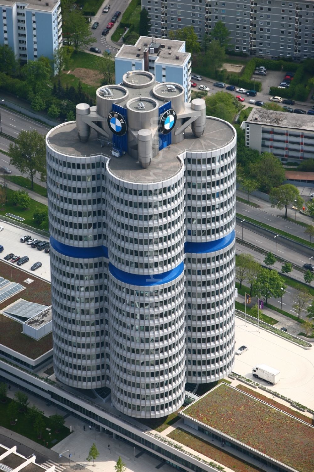 Aerial photograph München - The skyscraper BMW Headquarters in Munich in Bavaria is part of the corporate headquarters of the car manufacturer BMW. The building consists of four office towers that are arranged as a four cylinder. Designed the BMW Tower by architect Karl Schwanzer