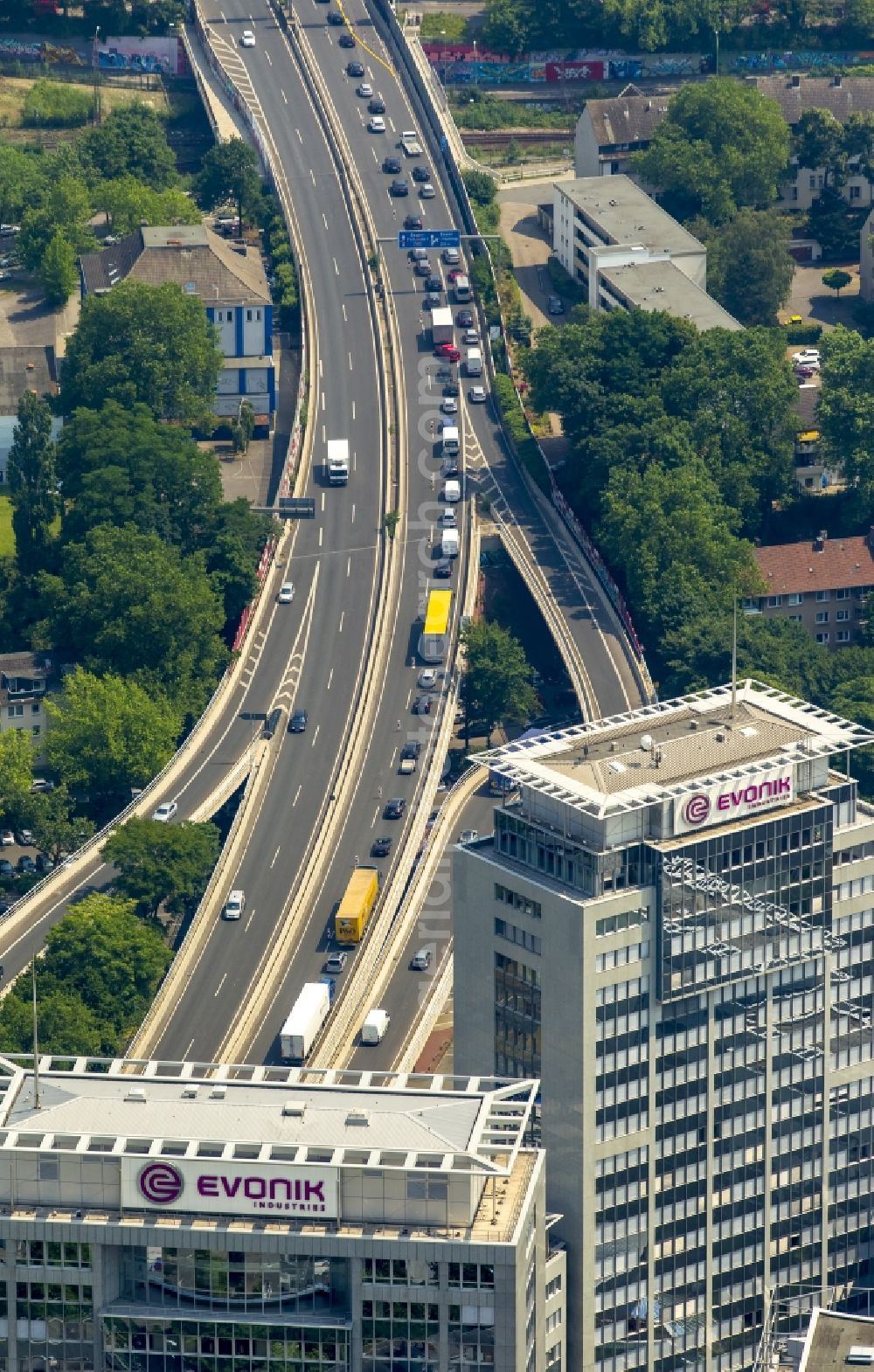 Essen from above - High-rise office buildings of Evonik Industries AG in Essen in the state of North Rhine-Westphalia. The office building complex with the writings on the roof is located on federal motorway A40 in the South of the Centre of Essen