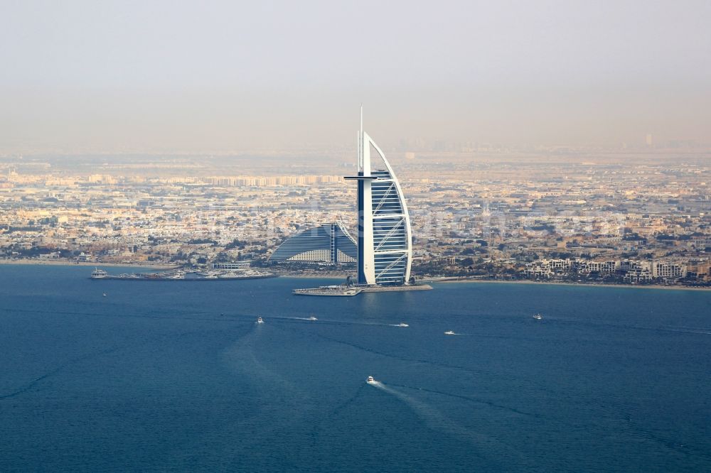 Dubai from the bird's eye view: High-rise building of the hotel complex Burj Al Arab Jumeirah in the coastal area of the Persian Gulf in the district Umm Suqeim in Dubai in United Arab Emirates
