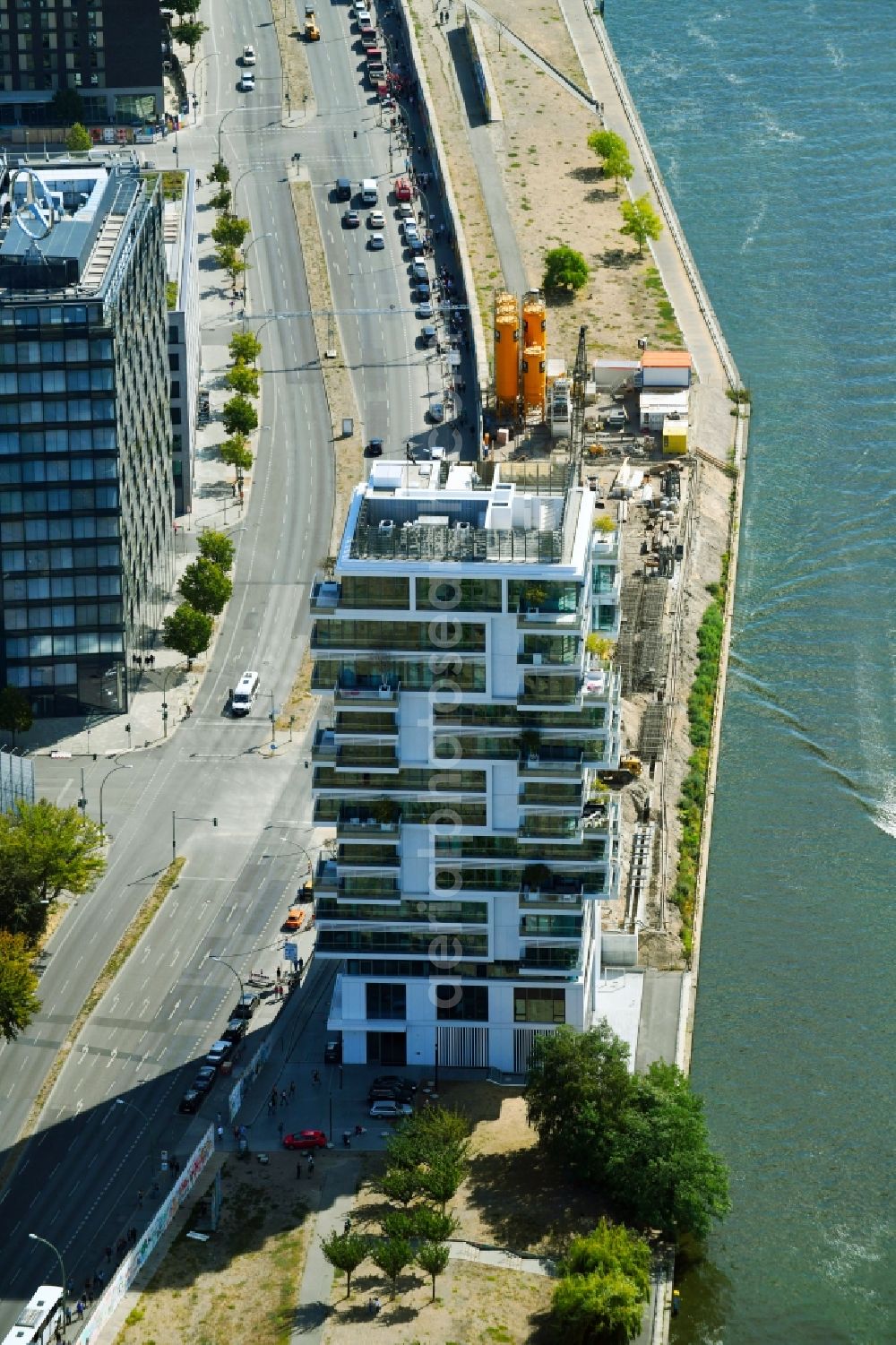 Berlin from above - Project Living Levels at Muhlenstrasse on the banks of the River Spree in Berlin - Friedrichshain. On the grounds of the Berlin Wall border strip at the EastSideGallery, the company Living Bauhaus is building a futuristic high-rise residential. The real estate service company City & Home GmbH manages the available apartments