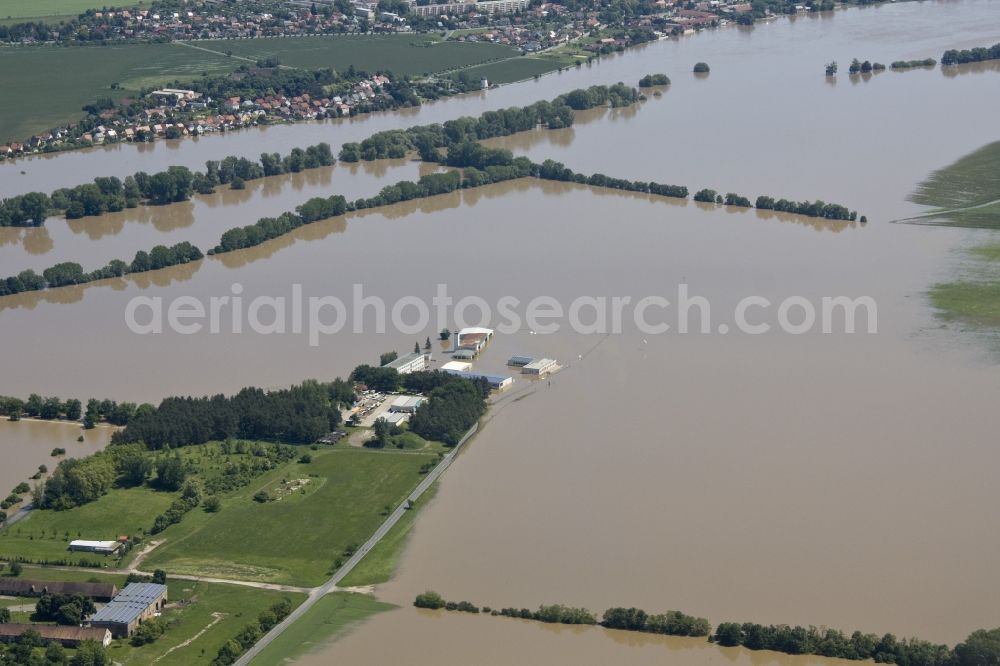 Aerial image Riesa - Flood disaster flood flooding the banks of the Elbe and the surrounding areas in Riesa in Saxony. The start and runway of the airfield is under water, the operating building and the hangars are unusable