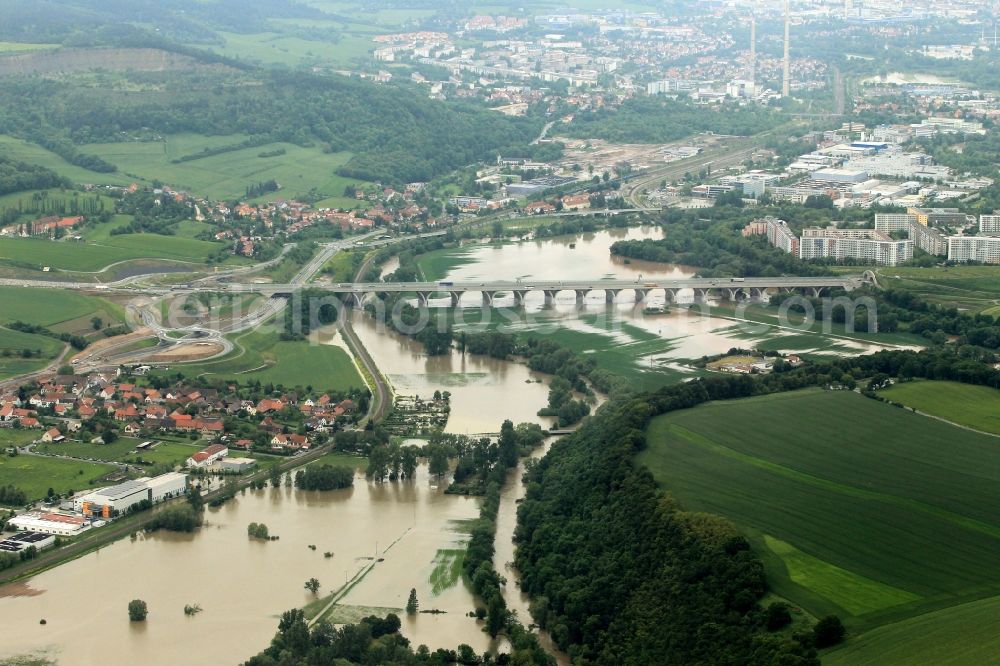 Jena from the bird's eye view: Flood flood disaster with the level crossing of the Saale and the Oberaue flooding along the highway in Jena in Thuringia