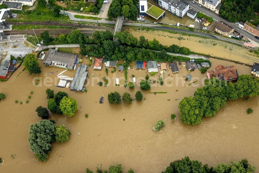 Bochum from the bird's eye view: Flood situation and flooding, all-rousing and infrastructure-destroying masses of brown water at the train station in the district Dahlhausen in Bochum at Ruhrgebiet in the state North Rhine-Westphalia, Germany