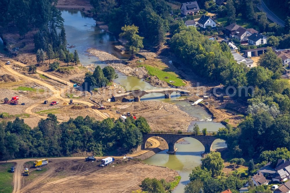 Dümpelfeld from above - Flood situation and flooding, all-rousing and infrastructure-destroying masses of brown water at the river Ahr with a destroyed bridge in Duempelfeld in the state Rhineland-Palatinate, Germany