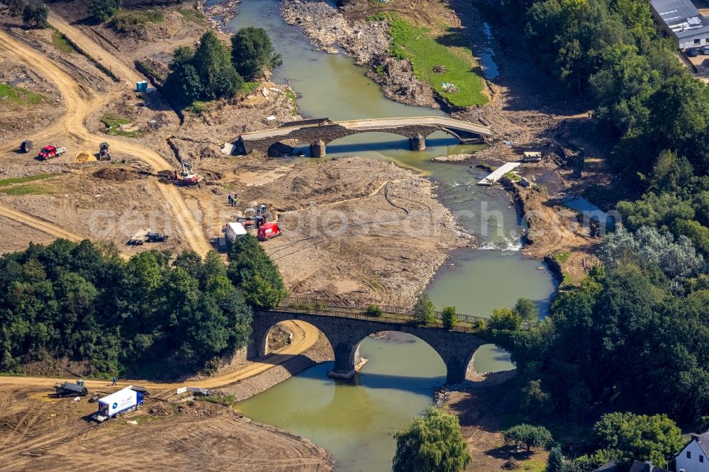 Aerial photograph Dümpelfeld - Flood situation and flooding, all-rousing and infrastructure-destroying masses of brown water at the river Ahr with a destroyed bridge in Duempelfeld in the state Rhineland-Palatinate, Germany