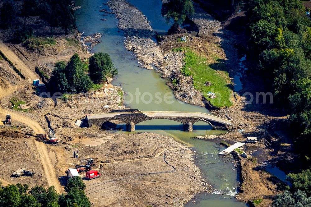 Dümpelfeld from above - Flood situation and flooding, all-rousing and infrastructure-destroying masses of brown water at the river Ahr with a destroyed bridge in Duempelfeld in the state Rhineland-Palatinate, Germany