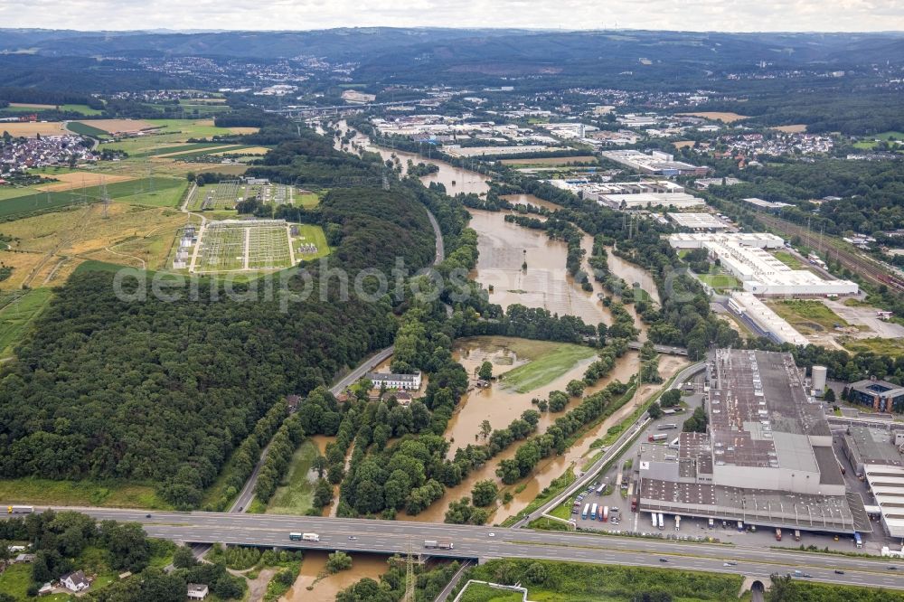 Hagen from the bird's eye view: Flood situation and flooding, all-rousing and infrastructure-destroying masses of brown water on the course of the river Lenne in Hagen at Ruhrgebiet in the state North Rhine-Westphalia, Germany