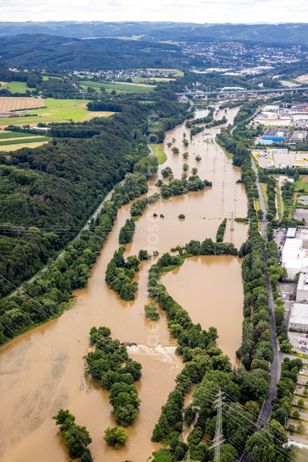 Hagen from the bird's eye view: Flood situation and flooding, all-rousing and infrastructure-destroying masses of brown water on the course of the river Lenne in Hagen at Ruhrgebiet in the state North Rhine-Westphalia, Germany