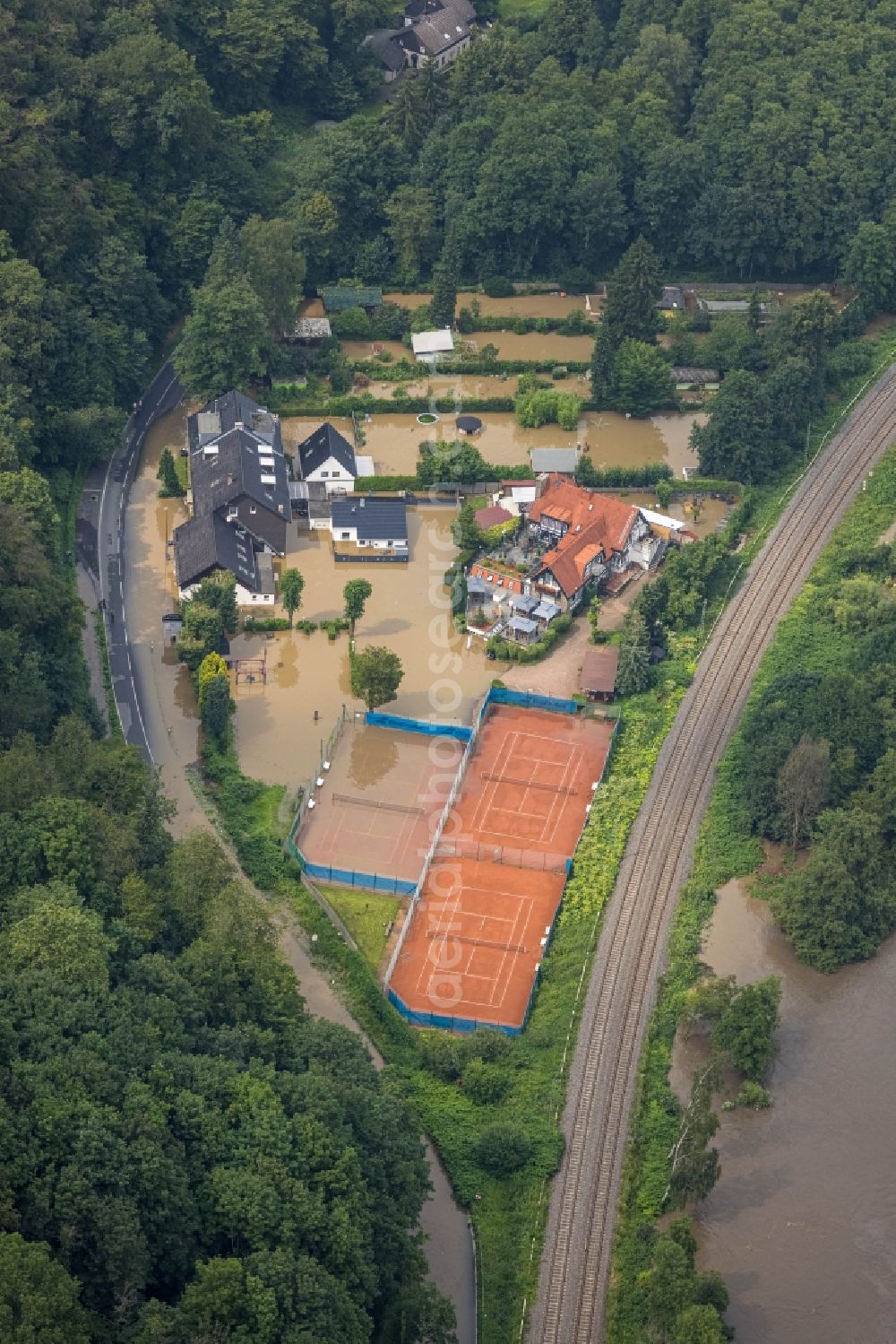 Essen from the bird's eye view: Flood situation and flooding, all-rousing and infrastructure-destroying masses of brown water on the course of the river Ruhr in the district Kettwig in Essen at Ruhrgebiet in the state North Rhine-Westphalia, Germany