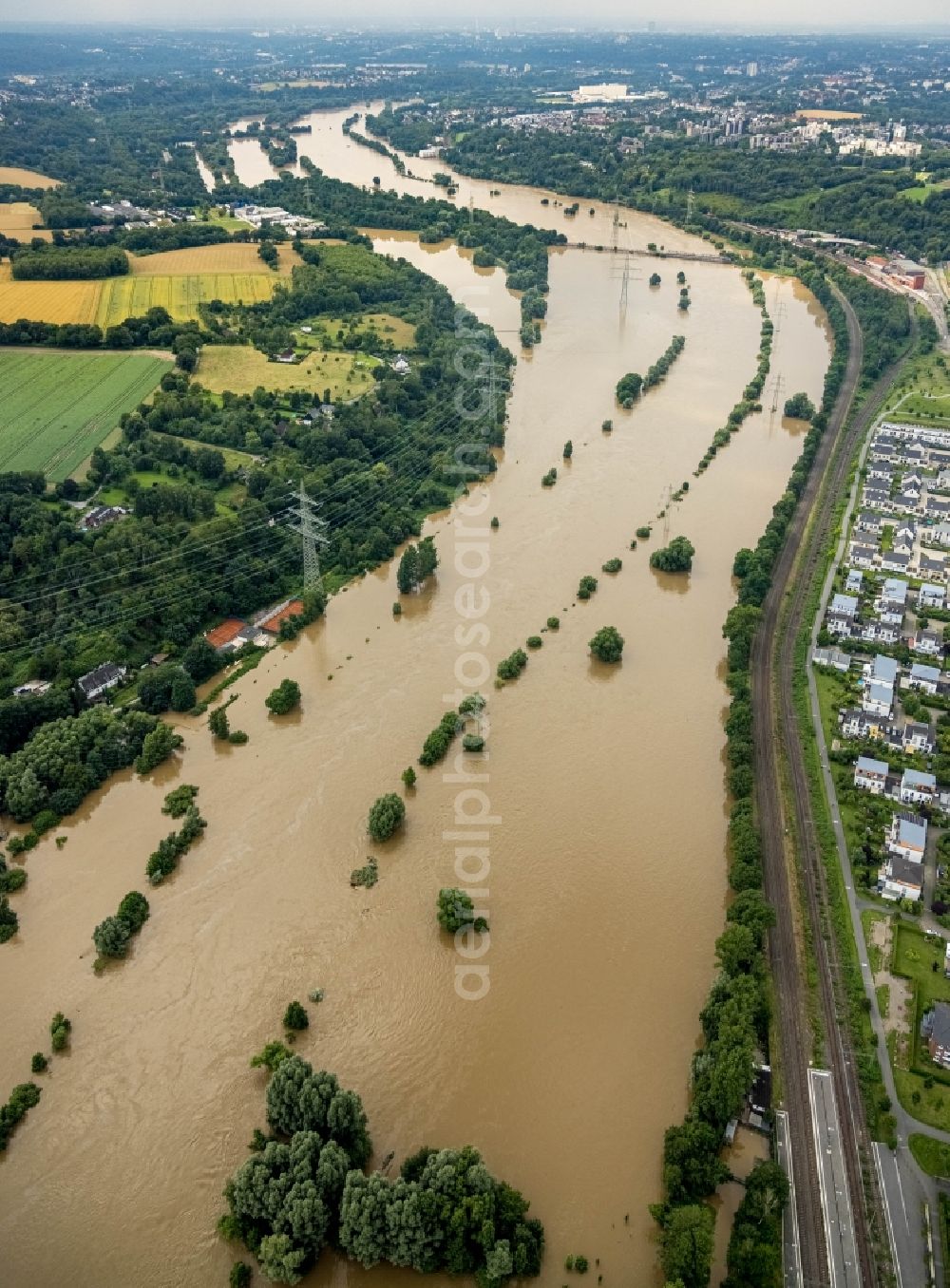 Aerial image Essen - Flood situation and flooding, all-rousing and infrastructure-destroying masses of brown water on the course of the river Ruhr in the district Ueberruhr - Hinsel in Essen at Ruhrgebiet in the state North Rhine-Westphalia, Germany