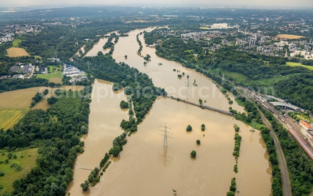 Essen from above - Flood situation and flooding, all-rousing and infrastructure-destroying masses of brown water on the course of the river Ruhr in the district Ueberruhr - Hinsel in Essen at Ruhrgebiet in the state North Rhine-Westphalia, Germany