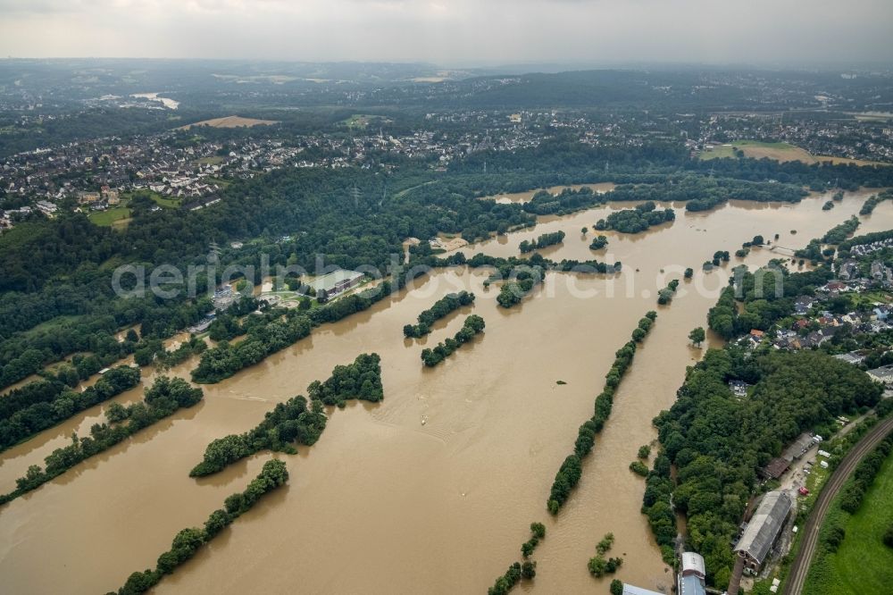 Essen from the bird's eye view: Flood situation and flooding, all-rousing and infrastructure-destroying masses of brown water on the course of the river Ruhr in the district Ueberruhr - Hinsel in Essen at Ruhrgebiet in the state North Rhine-Westphalia, Germany