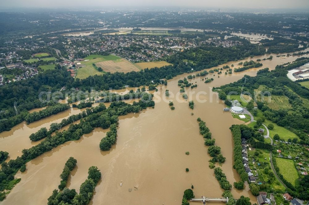 Essen from above - Flood situation and flooding, all-rousing and infrastructure-destroying masses of brown water on the course of the river Ruhr in the district Ueberruhr - Hinsel in Essen at Ruhrgebiet in the state North Rhine-Westphalia, Germany