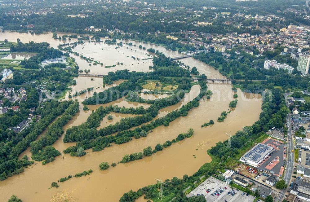 Aerial photograph Essen - Flood situation and flooding, all-rousing and infrastructure-destroying masses of brown water on the course of the river Ruhr in the district Ueberruhr - Hinsel in Essen at Ruhrgebiet in the state North Rhine-Westphalia, Germany