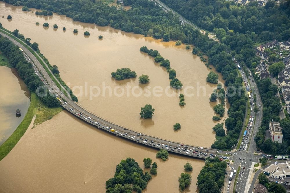 Essen from the bird's eye view: Flood situation and flooding, all-rousing and infrastructure-destroying masses of brown water on the course of the river Ruhr in the district Ueberruhr - Hinsel in Essen at Ruhrgebiet in the state North Rhine-Westphalia, Germany