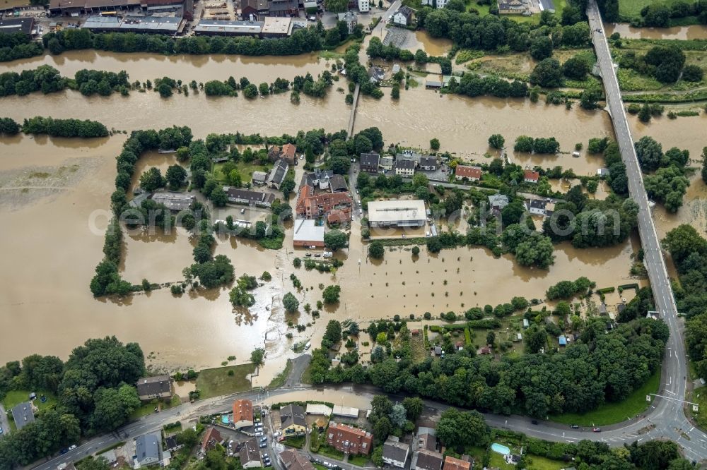 Witten from the bird's eye view: Flood situation and flooding, all-rousing and infrastructure-destroying masses of brown water on the course of the river Ruhr In der Lake in Witten at Ruhrgebiet in the state North Rhine-Westphalia, Germany