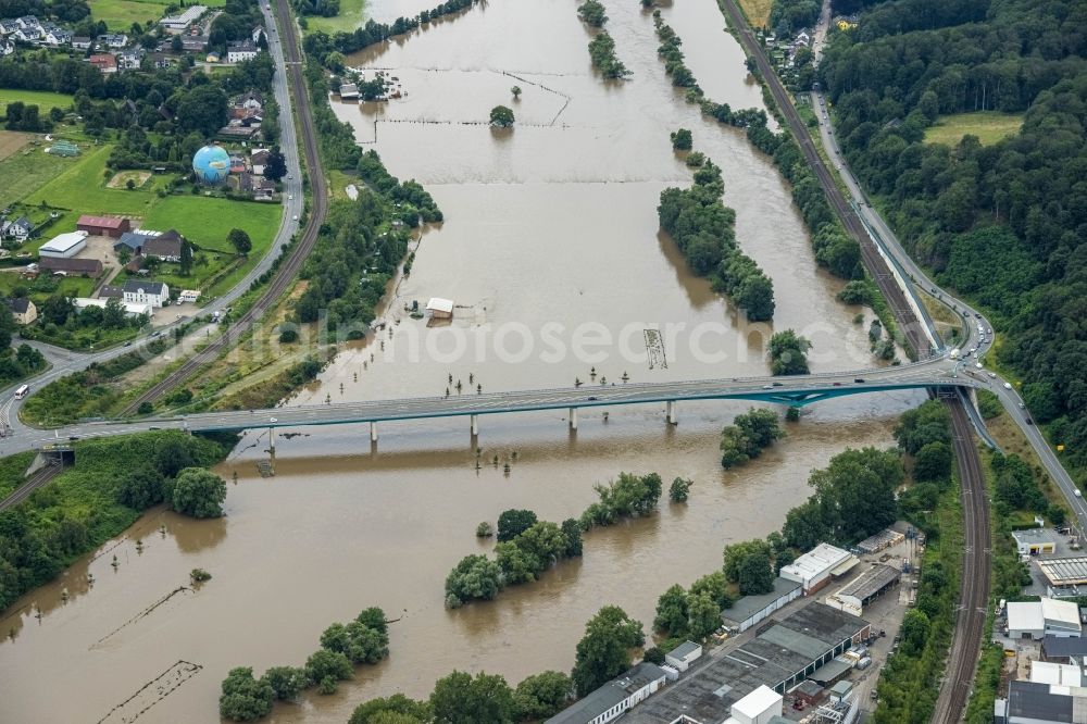 Wetter (Ruhr) from the bird's eye view: Flood situation and flooding, all-rousing and infrastructure-destroying masses of brown water on the course of the river Ruhr at the Neue Ruhrbruecke Wetter below Gederner Strasse - federal road B226 in Wetter (Ruhr) at Ruhrgebiet in the state North Rhine-Westphalia, Germany