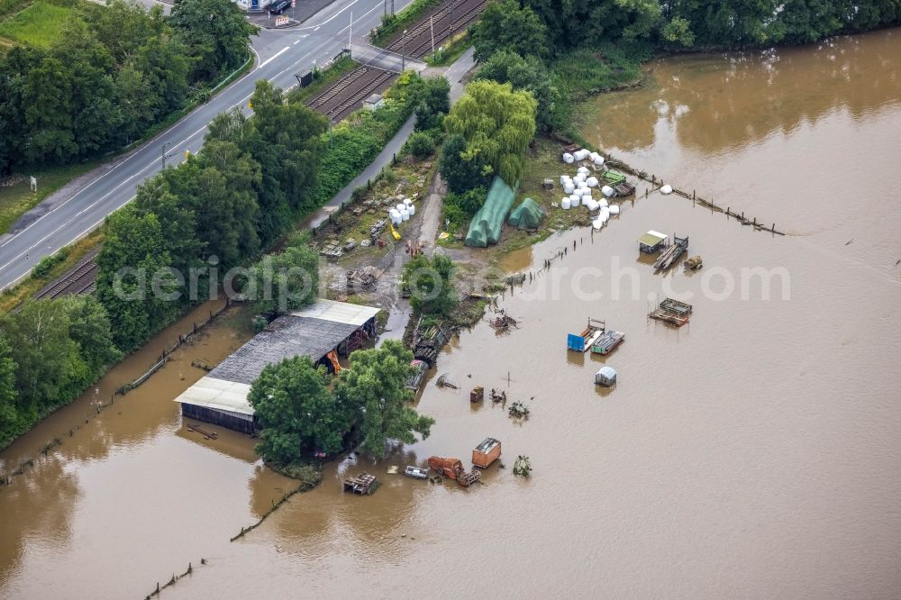 Aerial photograph Wetter (Ruhr) - Flood situation and flooding, all-rousing and infrastructure-destroying masses of brown water on the course of the river Ruhr on the Ruhrtal cycle path in Wetter (Ruhr) at Ruhrgebiet in the state North Rhine-Westphalia, Germany