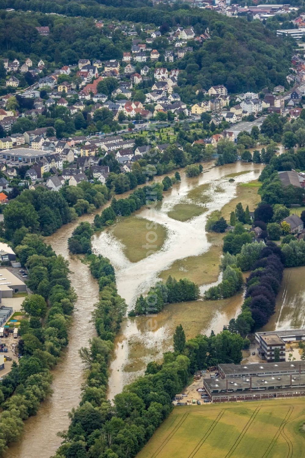 Hagen from the bird's eye view: Flood situation and flooding, all-rousing and infrastructure-destroying masses of brown water in the district Hohenlimburg in Hagen at Ruhrgebiet in the state North Rhine-Westphalia, Germany