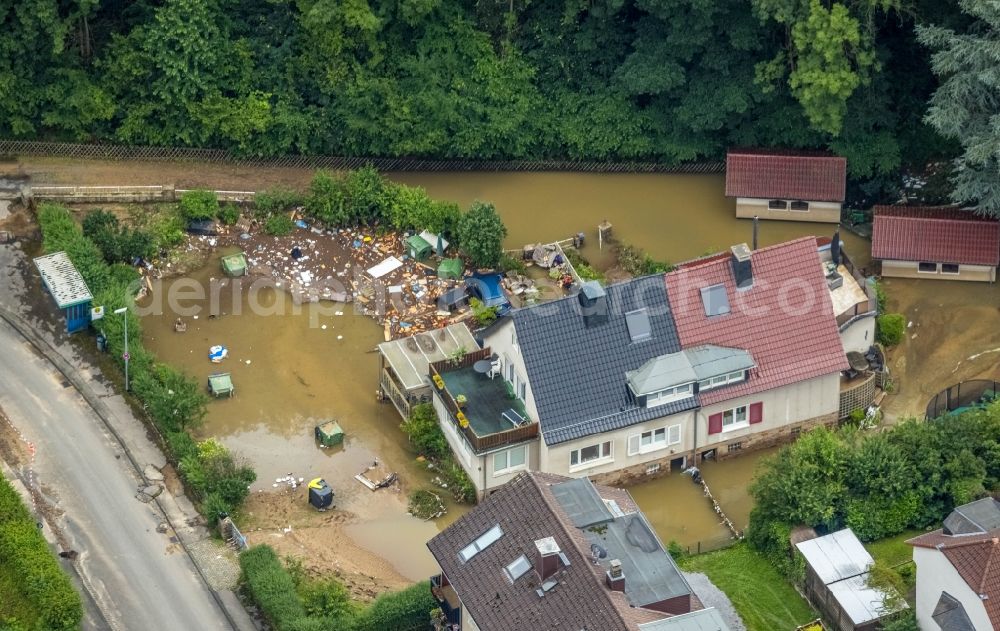 Hagen from the bird's eye view: Flood situation and flooding, all-rousing and infrastructure-destroying masses of brown water in the district Hohenlimburg in Hagen at Ruhrgebiet in the state North Rhine-Westphalia, Germany