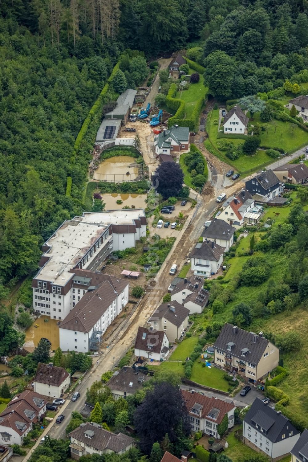 Hagen from above - Flood situation and flooding, all-rousing and infrastructure-destroying masses of brown water in the district Hohenlimburg in Hagen at Ruhrgebiet in the state North Rhine-Westphalia, Germany