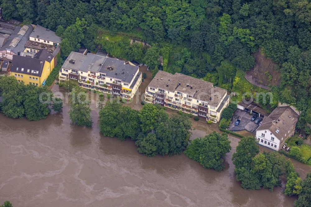 Essen from above - Flood situation and flooding, all-rousing and infrastructure-destroying masses of brown water on Laupendahler Landstrasse in the district Werden in Essen at Ruhrgebiet in the state North Rhine-Westphalia, Germany