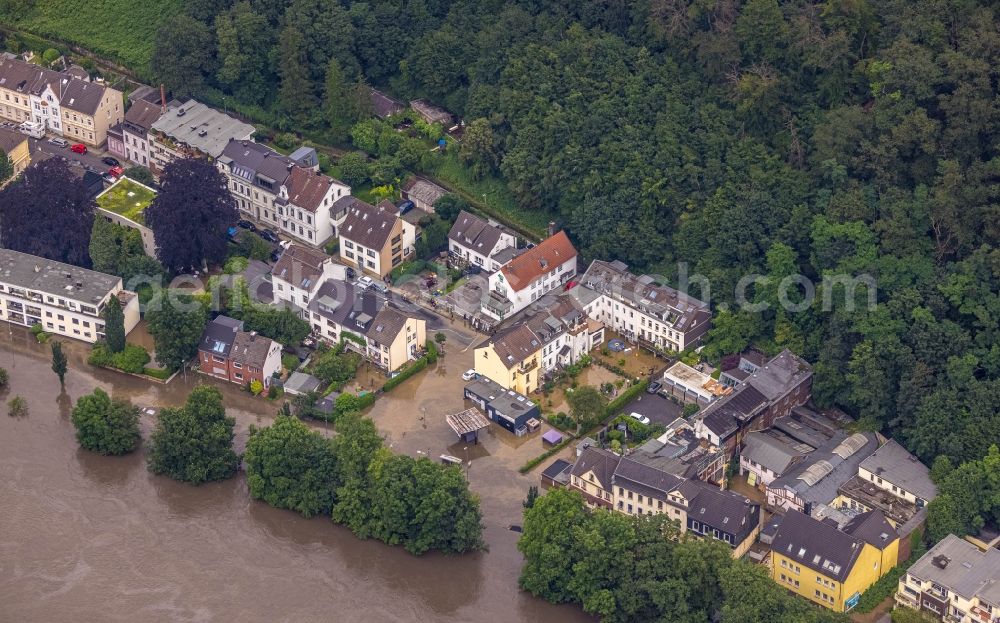 Essen from the bird's eye view: Flood situation and flooding, all-rousing and infrastructure-destroying masses of brown water on Laupendahler Landstrasse in the district Werden in Essen at Ruhrgebiet in the state North Rhine-Westphalia, Germany