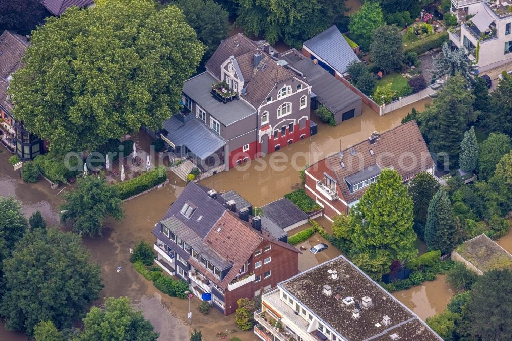 Aerial image Essen - Flood situation and flooding, all-rousing and infrastructure-destroying masses of brown water on Laupendahler Landstrasse in the district Werden in Essen at Ruhrgebiet in the state North Rhine-Westphalia, Germany