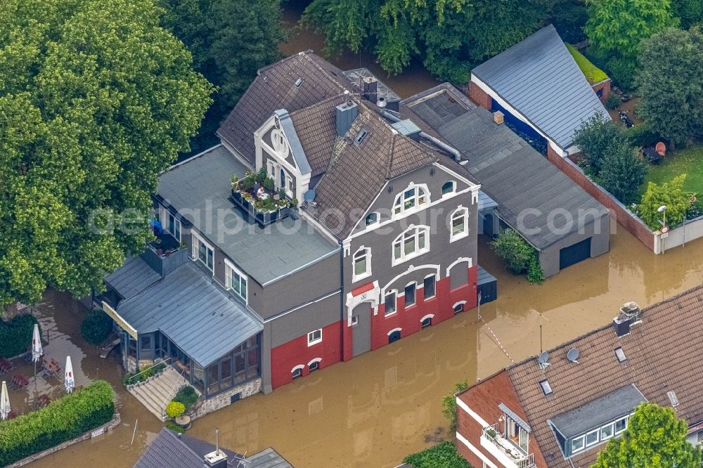 Aerial photograph Essen - Flood situation and flooding, all-rousing and infrastructure-destroying masses of brown water on Laupendahler Landstrasse in the district Werden in Essen at Ruhrgebiet in the state North Rhine-Westphalia, Germany