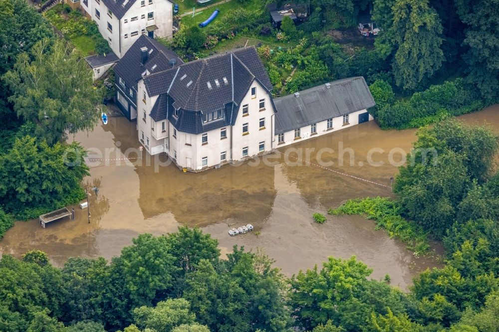 Aerial image Essen - Flood situation and flooding, all-rousing and infrastructure-destroying masses of brown water on Laupendahler Landstrasse in the district Werden in Essen at Ruhrgebiet in the state North Rhine-Westphalia, Germany