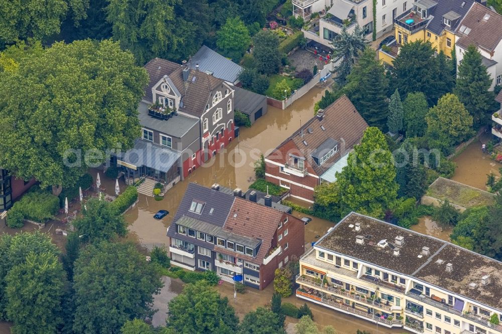 Aerial photograph Essen - Flood situation and flooding, all-rousing and infrastructure-destroying masses of brown water on Laupendahler Landstrasse in the district Werden in Essen at Ruhrgebiet in the state North Rhine-Westphalia, Germany