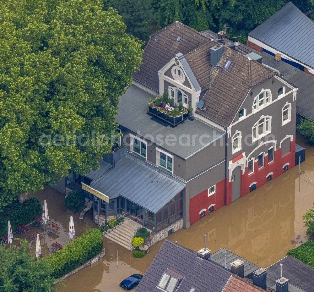 Essen from above - Flood situation and flooding, all-rousing and infrastructure-destroying masses of brown water on Laupendahler Landstrasse in the district Werden in Essen at Ruhrgebiet in the state North Rhine-Westphalia, Germany