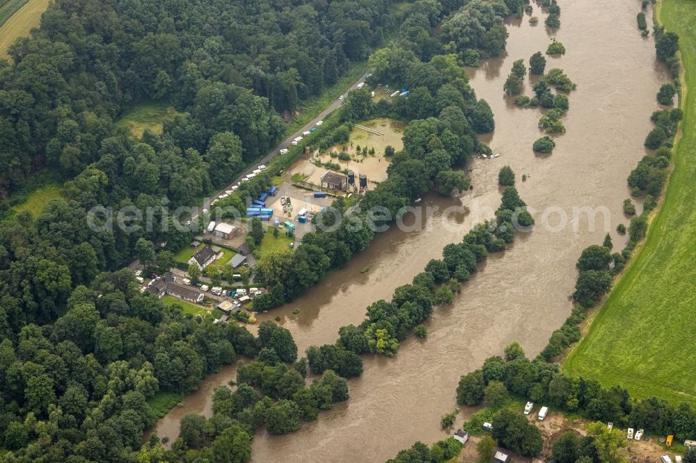 Essen from the bird's eye view: Flood situation and flooding, all-rousing and infrastructure-destroying masses of brown water on Laupendahler Landstrasse in the district Werden in Essen at Ruhrgebiet in the state North Rhine-Westphalia, Germany