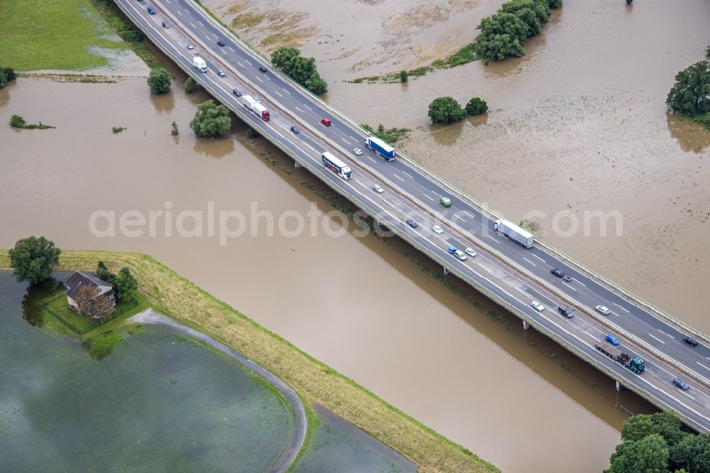 Schwerte from the bird's eye view: Flood situation and flooding, all-rousing and infrastructure-destroying masses of brown water Schwerte Ergste Autobahnbruecke E41 in Schwerte at Ruhrgebiet in the state North Rhine-Westphalia, Germany