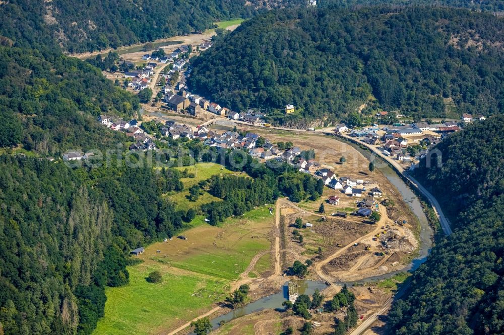 Ahrbrück from the bird's eye view: Flood damage and reconstruction construction sites in the floodplain on shore of Ahr in Ahrbrueck in the state Rhineland-Palatinate, Germany