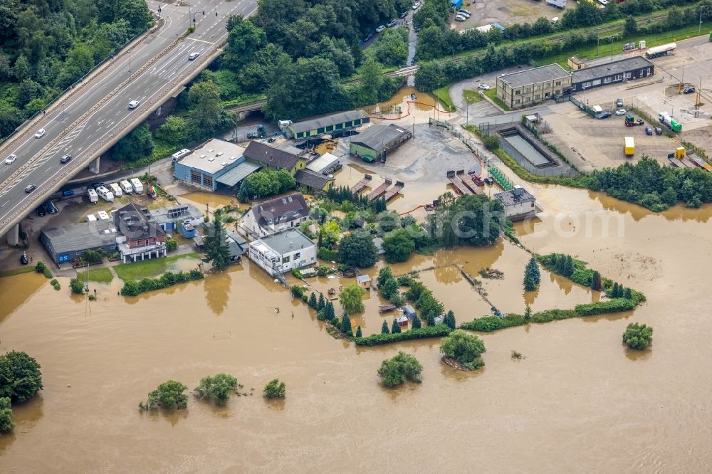 Hattingen from the bird's eye view: Flood situation and flooding, all-rousing and infrastructure-destroying masses of brown water on the course of the Ruhr in Hattingen at Ruhrgebiet in the state North Rhine-Westphalia, Germany