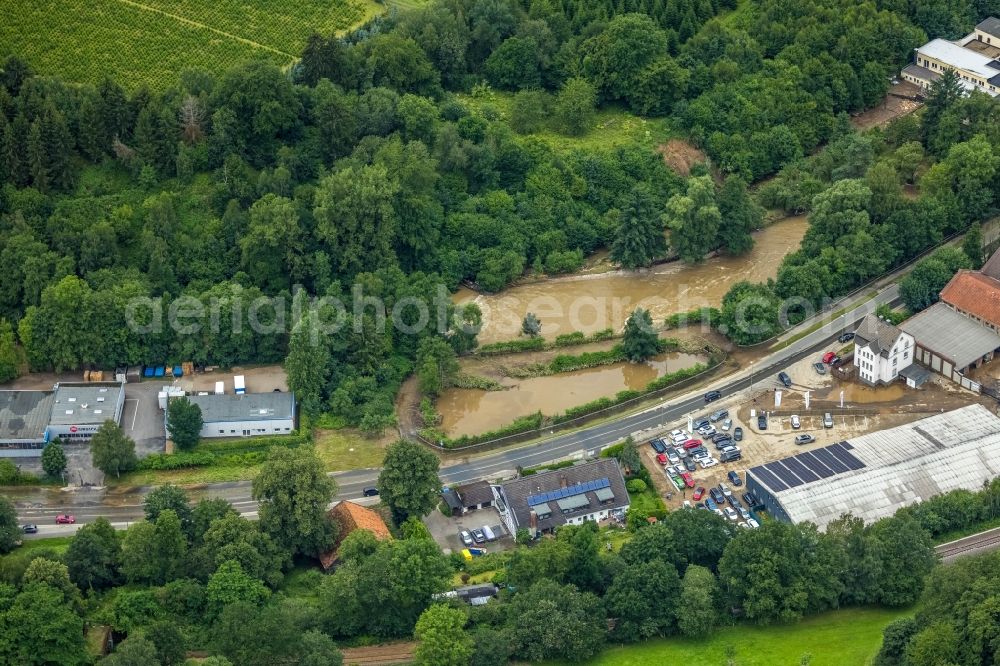 Hagen from the bird's eye view: Flood situation and flooding, all-rousing and infrastructure-destroying masses of brown water on the course of the Ruhr and Volme in Hagen at Ruhrgebiet in the state North Rhine-Westphalia, Germany