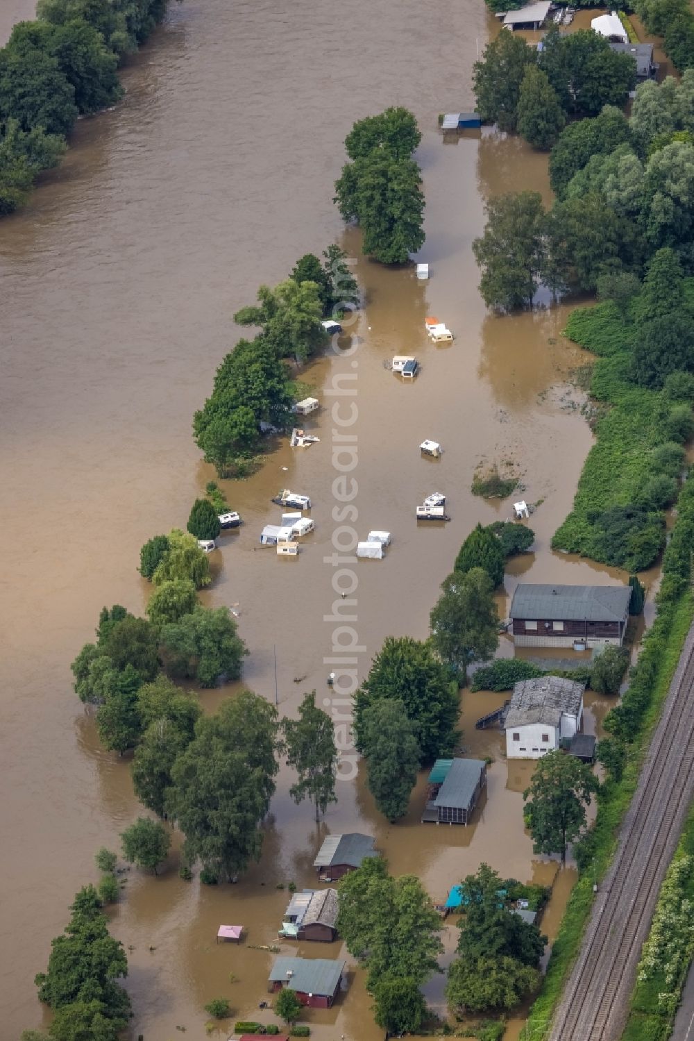 Witten from the bird's eye view: Flood situation and flooding, all-rousing and infrastructure-destroying masses of brown water on the course of the Ruhr in Witten at Ruhrgebiet in the state North Rhine-Westphalia, Germany