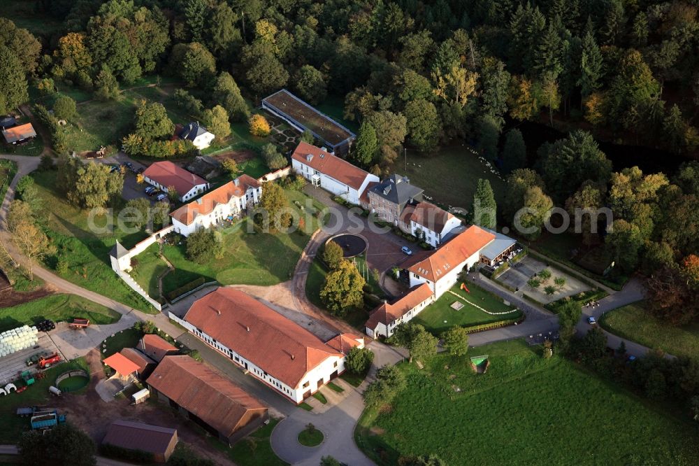 Tholey from above - The court and estate Imsbach in Tholey in the state of Saarland. The compound includes a hotel, an organic farm with a pet zoo and a wellness area. It is located in the nature park Saar-Hunsrueck, surrounded by the creeks Bitzenbach, Mandelbach and Imsbach